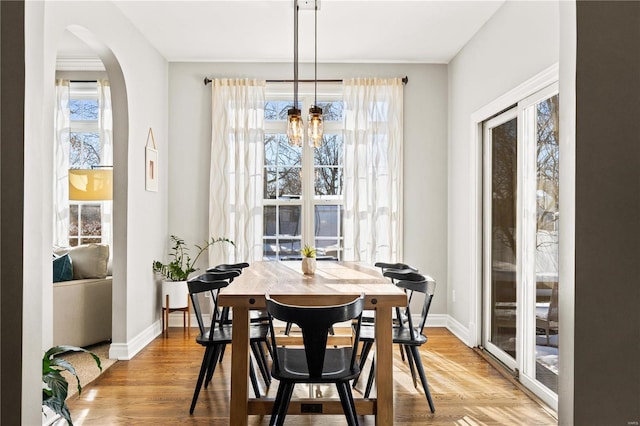 dining space with an inviting chandelier and hardwood / wood-style flooring