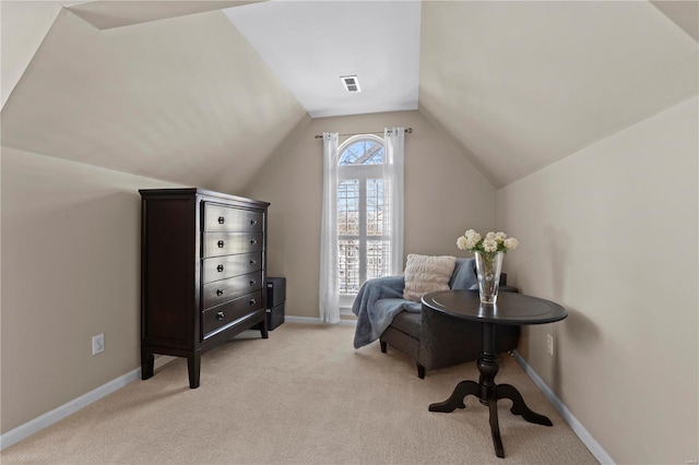 sitting room with light carpet and vaulted ceiling