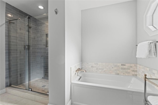 bathroom with tile patterned floors and independent shower and bath