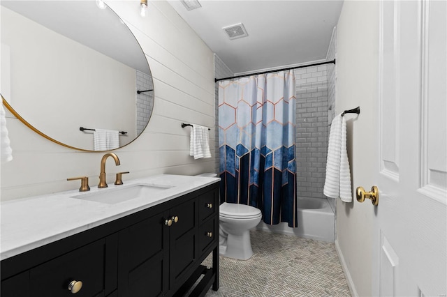 full bathroom featuring toilet, wooden walls, shower / bath combination with curtain, tile patterned floors, and vanity