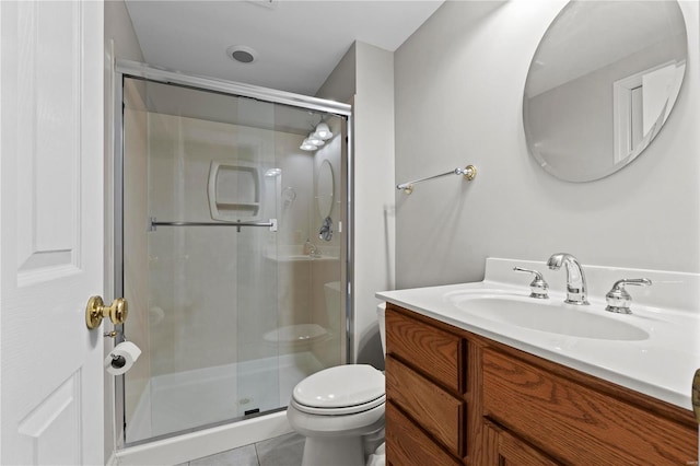 bathroom featuring vanity, tile patterned flooring, a shower with shower door, and toilet