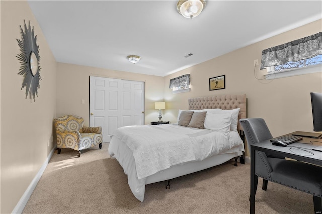 bedroom with a closet and light carpet