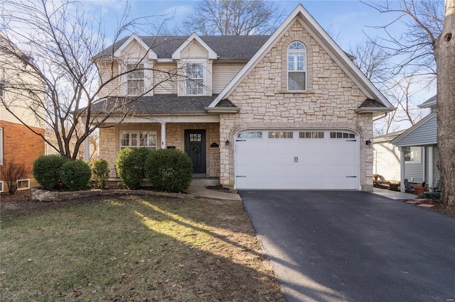 view of front of house featuring a front lawn and a garage