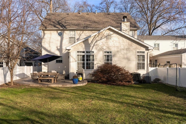 rear view of house with a yard, central AC unit, and a patio