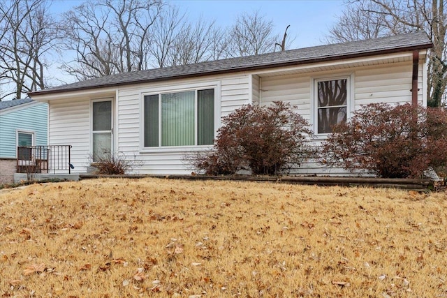 view of side of home featuring a lawn