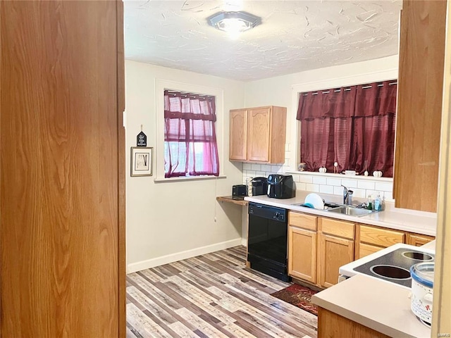 kitchen with dishwasher, sink, electric range, decorative backsplash, and light wood-type flooring