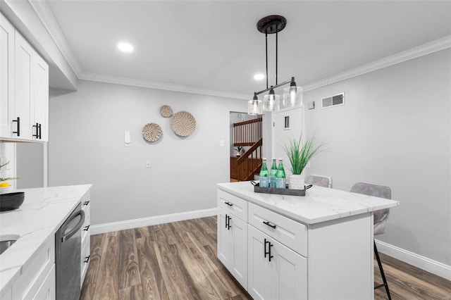 kitchen featuring a kitchen breakfast bar, light stone countertops, a kitchen island, white cabinetry, and stainless steel dishwasher