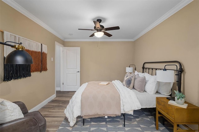 bedroom featuring ceiling fan, ornamental molding, and hardwood / wood-style floors