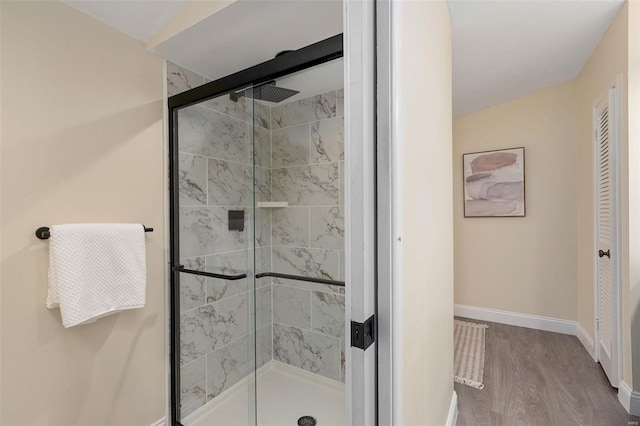 bathroom featuring walk in shower and hardwood / wood-style floors