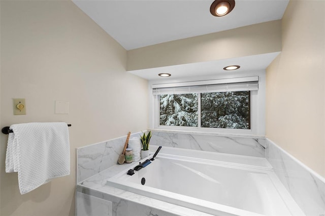 bathroom featuring tiled tub