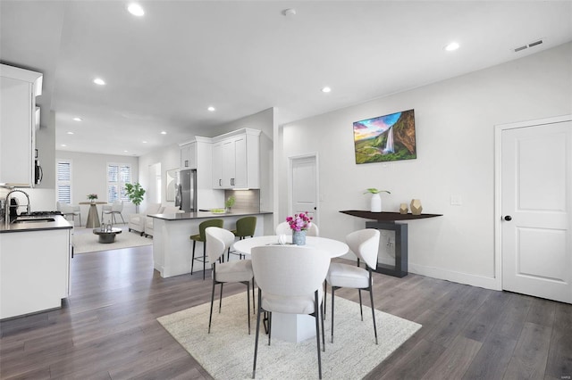 dining room with sink and dark hardwood / wood-style floors