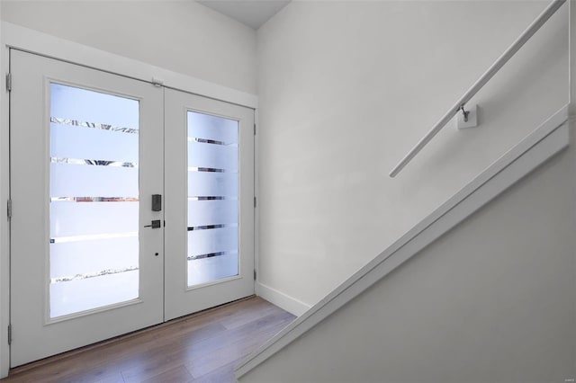 doorway with hardwood / wood-style floors and french doors