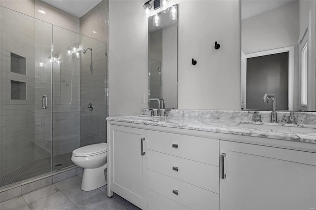 bathroom with toilet, vanity, and an enclosed shower