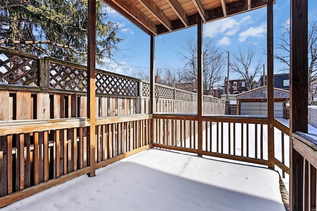 deck with a garage and an outbuilding