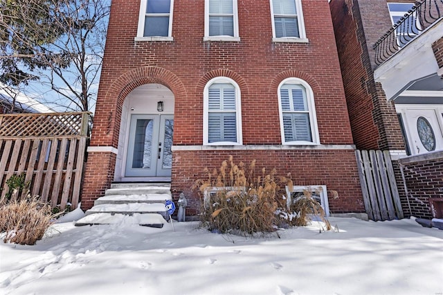 view of snow covered property entrance