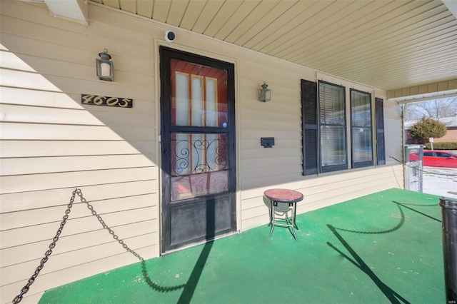 view of exterior entry featuring a porch