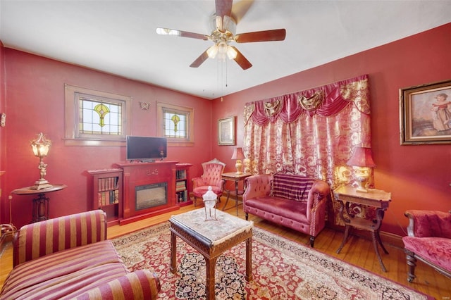 living room with hardwood / wood-style flooring and ceiling fan