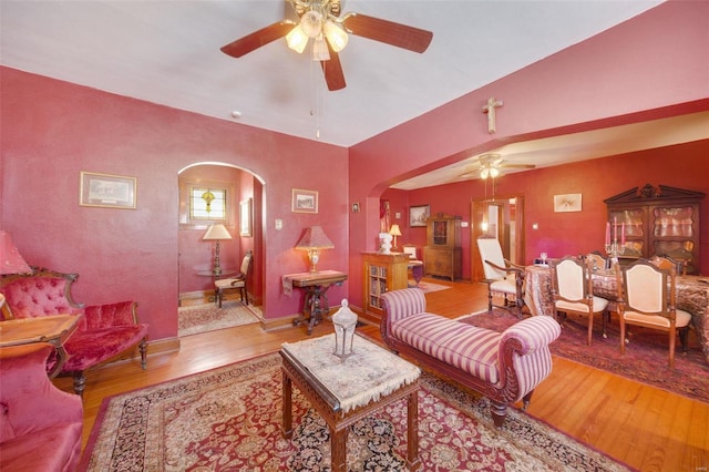 living room with ceiling fan and light hardwood / wood-style flooring