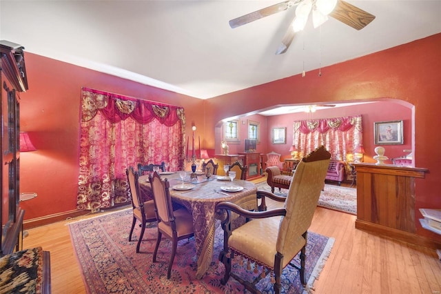 dining area with light wood-type flooring and ceiling fan