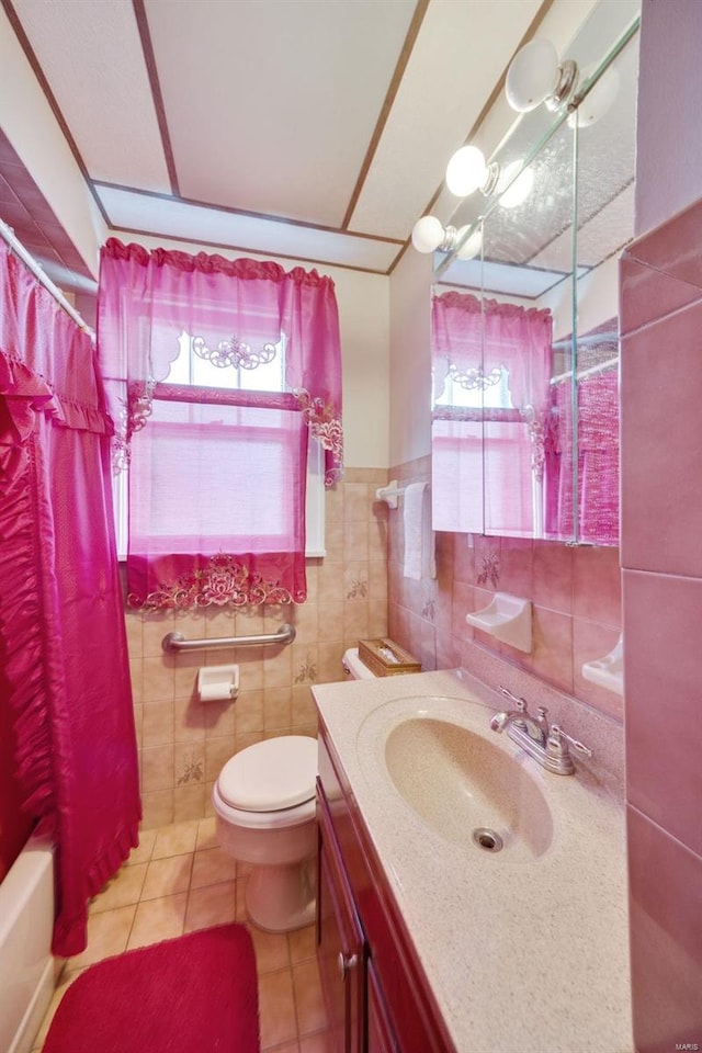 full bathroom with tile patterned floors, vanity, tile walls, toilet, and shower / tub combo with curtain