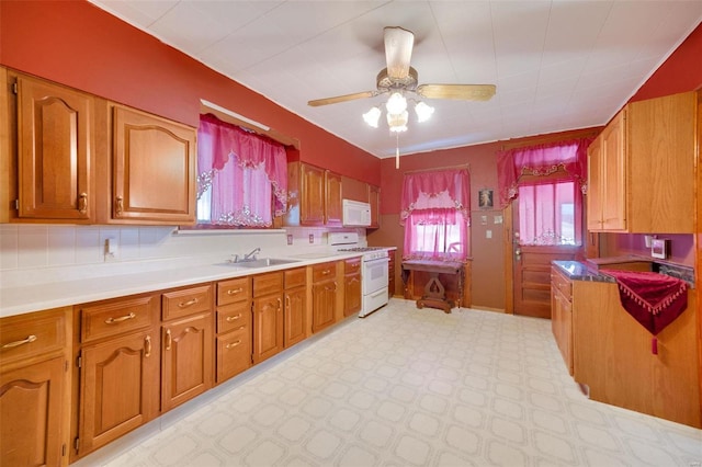 kitchen with ceiling fan, backsplash, and white appliances