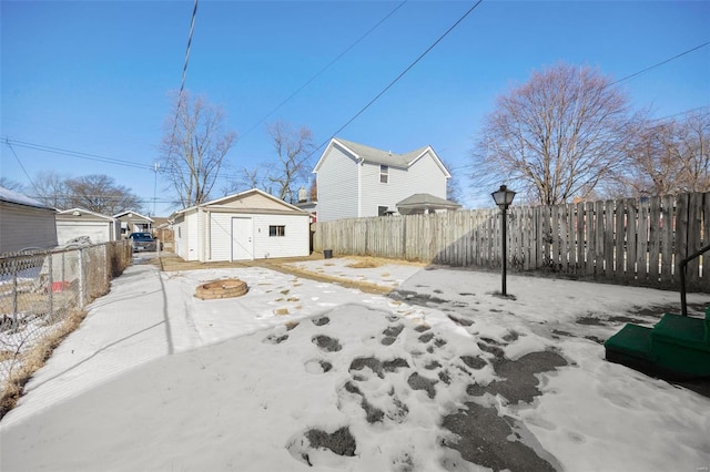 snowy yard with a storage shed