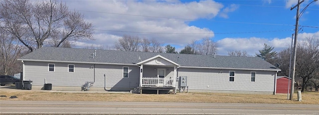 single story home with a front lawn and a porch