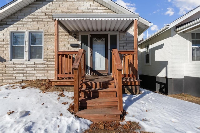 view of snow covered property entrance