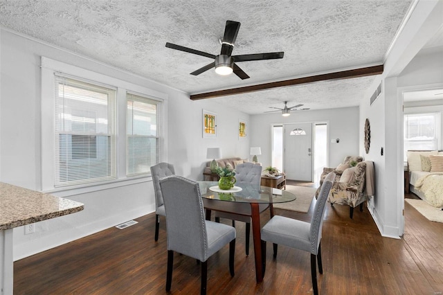 dining area featuring a textured ceiling, beamed ceiling, and dark hardwood / wood-style flooring