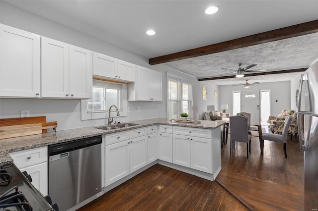 kitchen featuring sink, stainless steel dishwasher, white cabinets, and light stone countertops