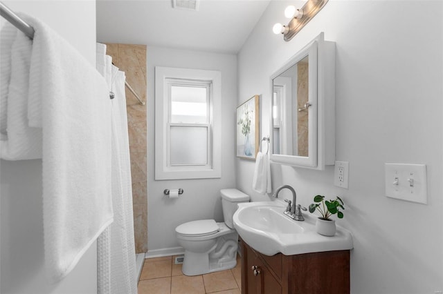 bathroom with curtained shower, toilet, tile patterned floors, and vanity