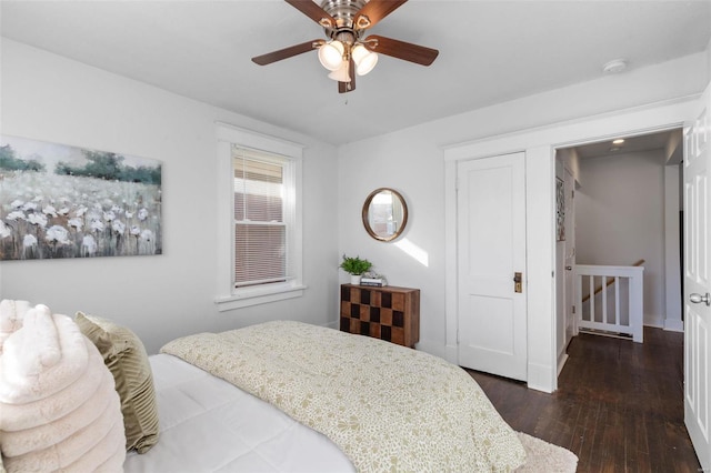 bedroom with ceiling fan and dark hardwood / wood-style floors