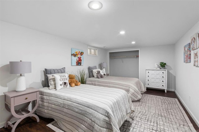 bedroom with a closet and dark wood-type flooring