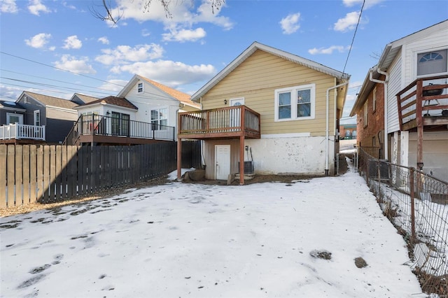 view of snow covered rear of property