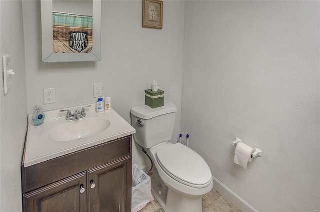 bathroom with tile patterned flooring, vanity, and toilet