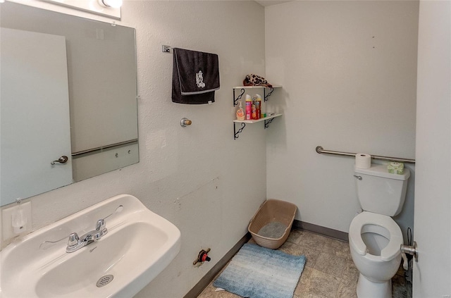 bathroom featuring sink and toilet