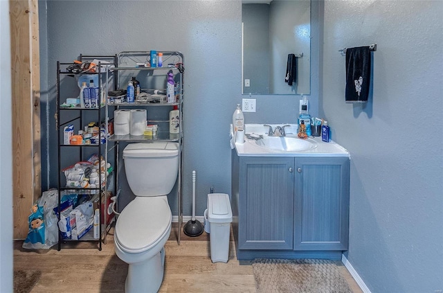 bathroom featuring hardwood / wood-style floors, vanity, and toilet