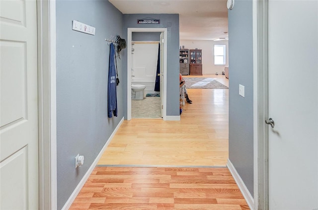 corridor with light hardwood / wood-style floors