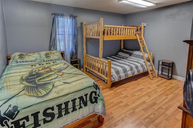 bedroom featuring light wood-style flooring and baseboards