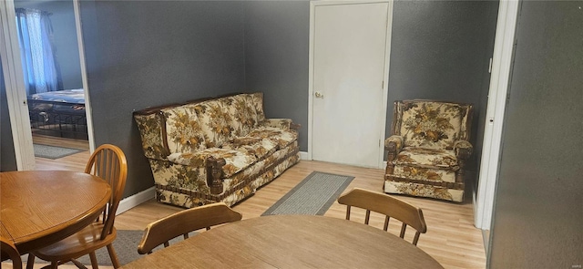 sitting room featuring light wood-type flooring and baseboards