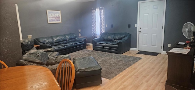 living area featuring light wood finished floors and baseboards