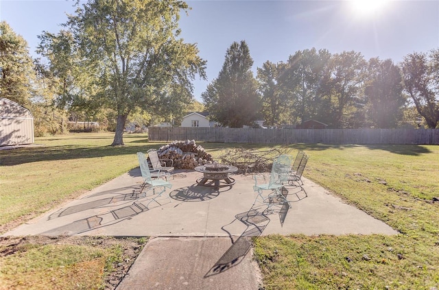 view of patio featuring an outdoor fire pit and fence