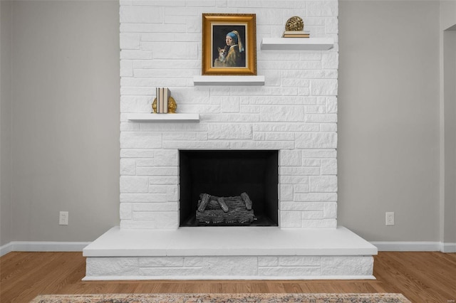 details featuring a stone fireplace and hardwood / wood-style floors