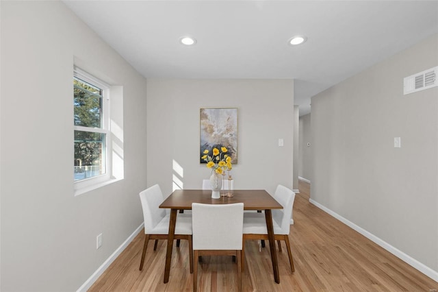 dining space with light wood-type flooring and a wealth of natural light