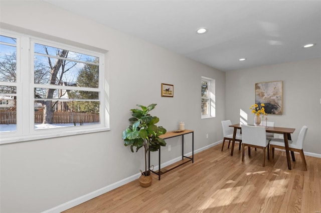 dining room featuring a wealth of natural light and light hardwood / wood-style floors