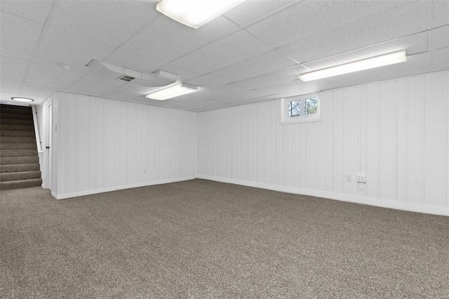 basement featuring carpet and a drop ceiling