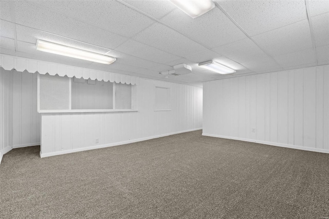 carpeted spare room featuring a paneled ceiling