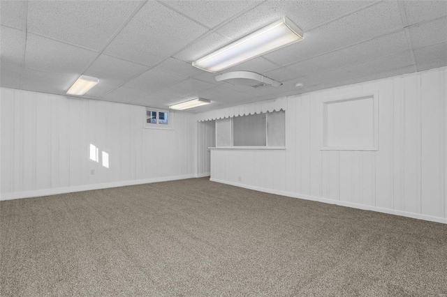 basement with carpet floors and a paneled ceiling