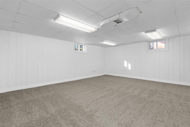 basement with carpet floors and a drop ceiling