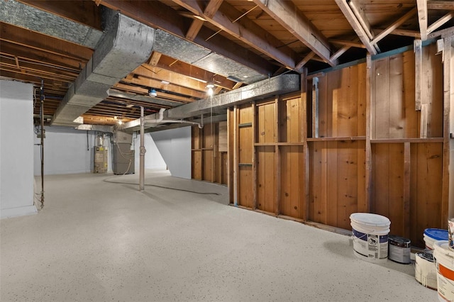 basement with heating unit, wood walls, and gas water heater